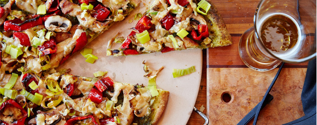 Chicken, leek, red bell pepper and mushroom pizza with pesto and cheese on Naan bread