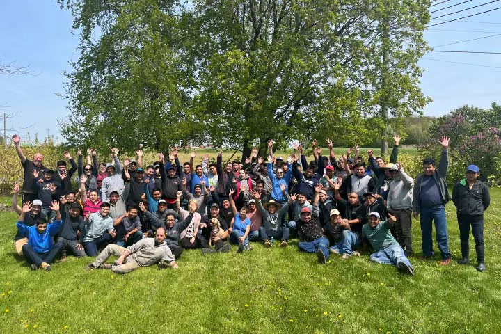 Family and employees at Les Cultures de chez nous during a summer BBQ