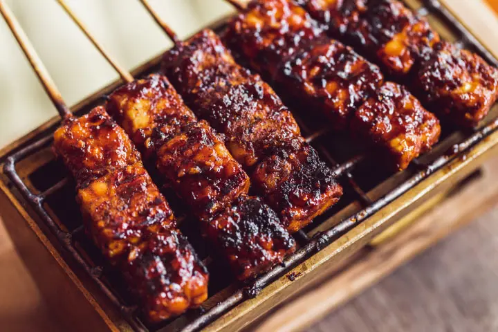 Skewers of tempeh in cubes cooked on the BBQ