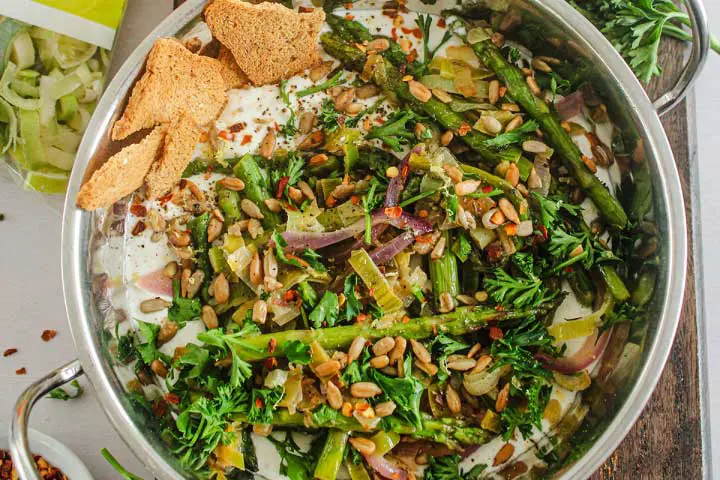 Green asparagus recipe: whipped feta with simple sautéed asparagus and leek and roasted sunflower seeds as garnish