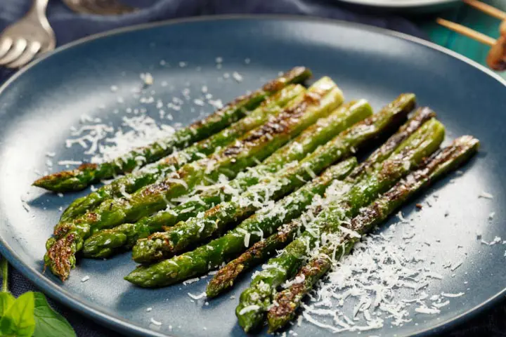 Grilled asparagus plate with grated parmesan cheese as garnish